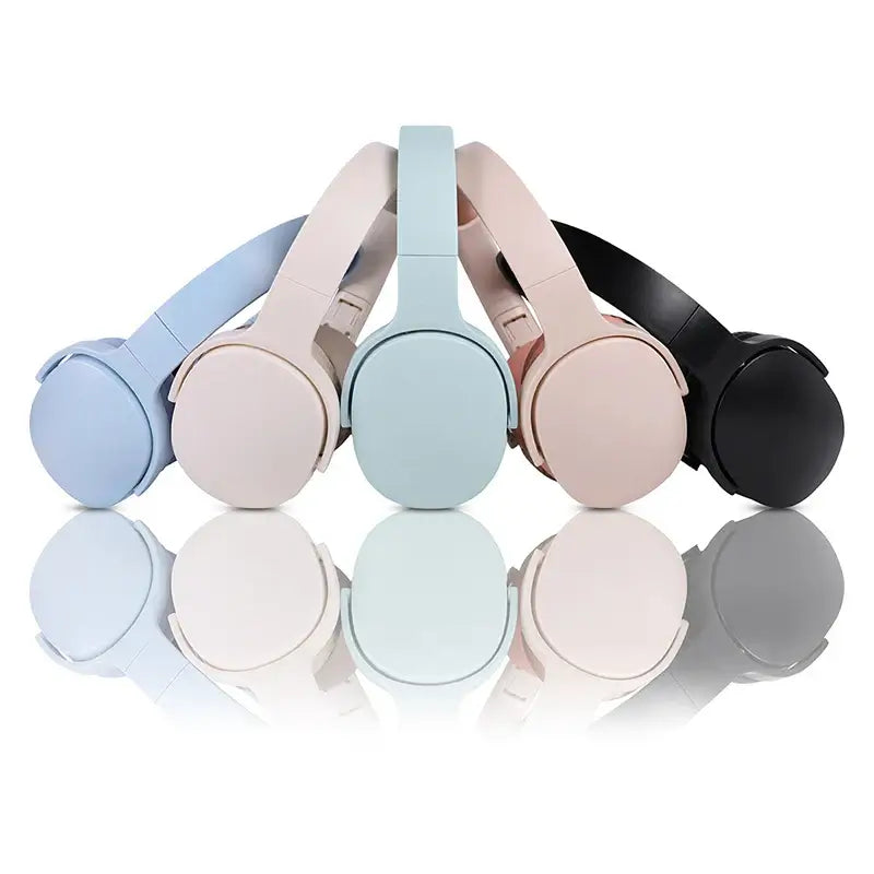 Stylish wireless headphones in pastel colors: blue, pink, and black, showcasing a modern design and sleek finish.